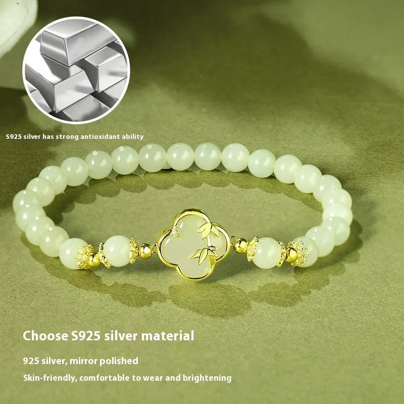 Hetian Jade festival bracelet and necklace set with inlaid jade leaf designs on bamboo newspaper tone background