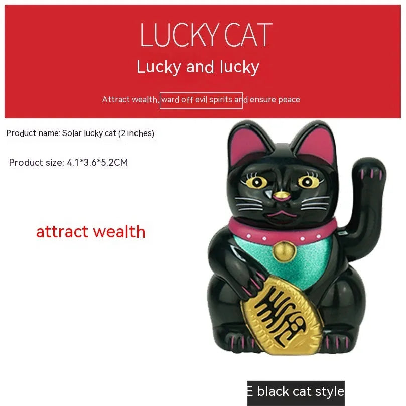 Small yellow solar powered Maneki Neko lucky cat decoration waving its arm.