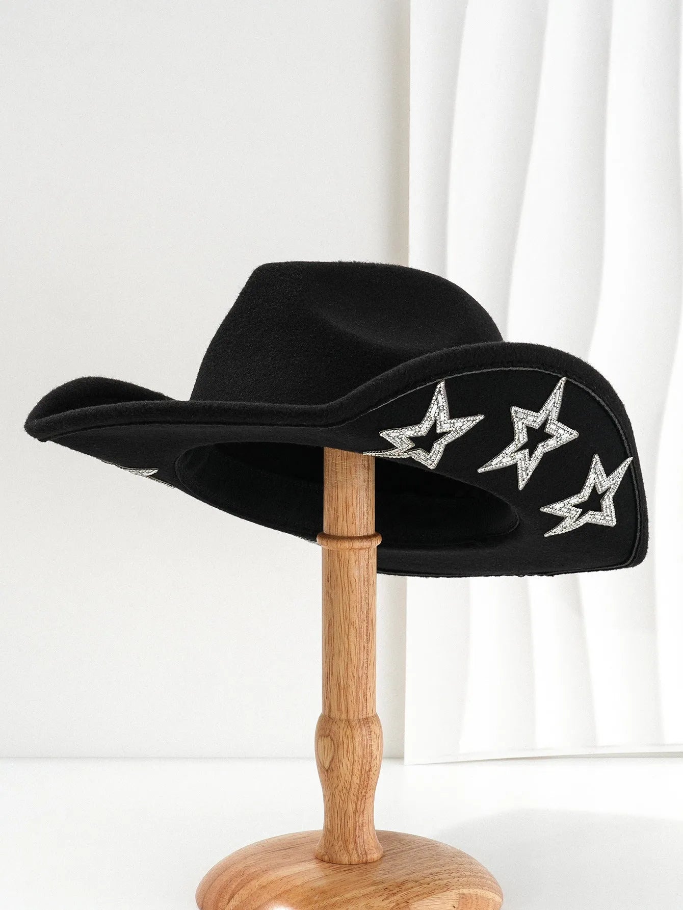 Beige wool felt western cowboy hat with a hexagonal star on the side, conical crown.