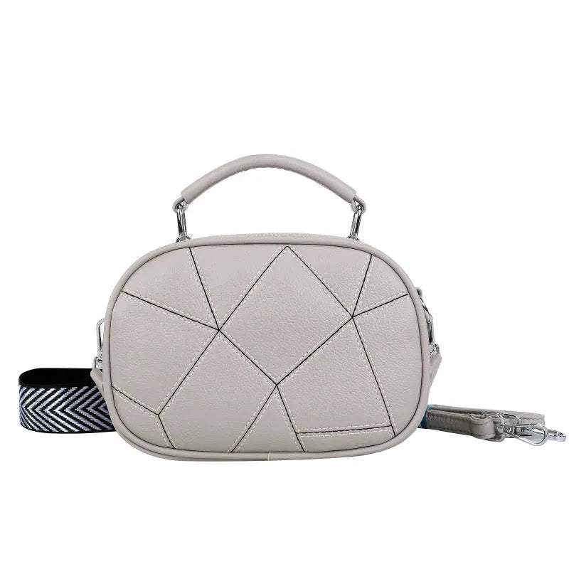 Round PU leather crossbody bag with patchwork design showing decorative stitching