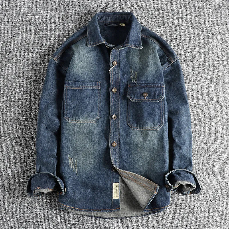 Men's light blue loose-fit vintage denim shirt with long sleeves on a hanger.