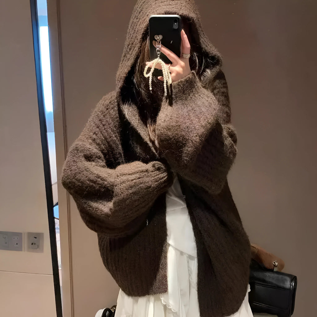 A woman's loose-fitting, hooded sweater cardigan in a solid colour, shown with regular sleeves.