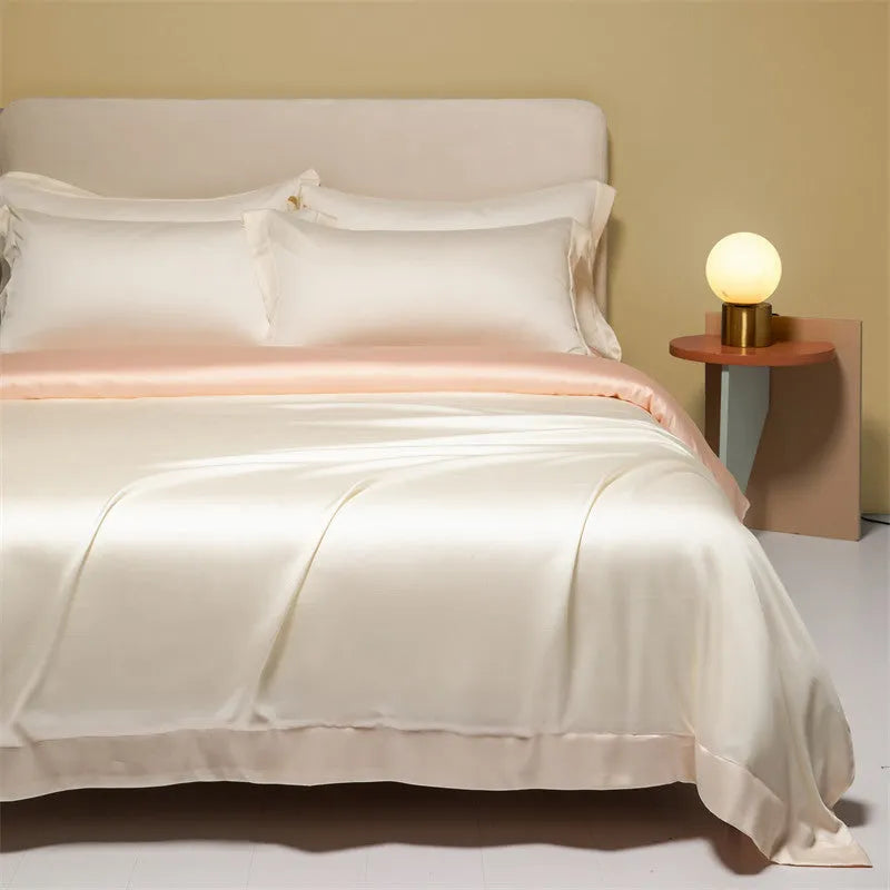 A neatly made bed with a Lenzing Tencel duvet cover and pillowcases in a soft grey colour.