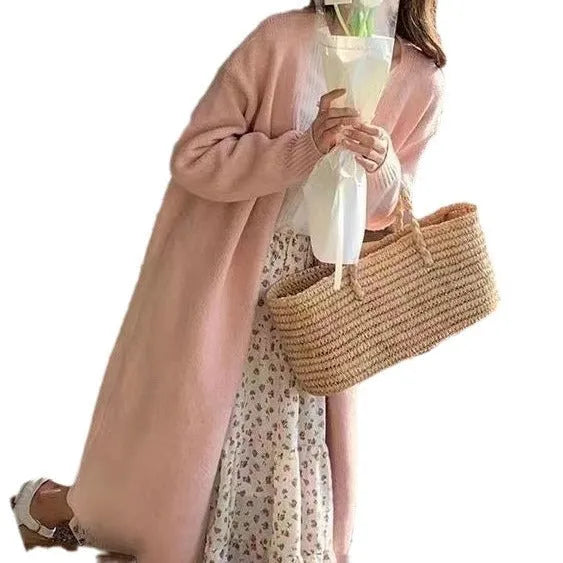 A women's khaki knitted V-neck cardigan with long sleeves, shown hanging to display its mid-length loose fit.