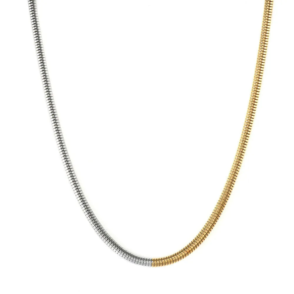 Close-up of a women's golden snake bone chain necklace with 3mm thick geometric stainless steel links.