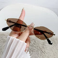 Gold metal small frame cat eye sunglasses shown with multiple lens colour options including grey, tea, and pink.