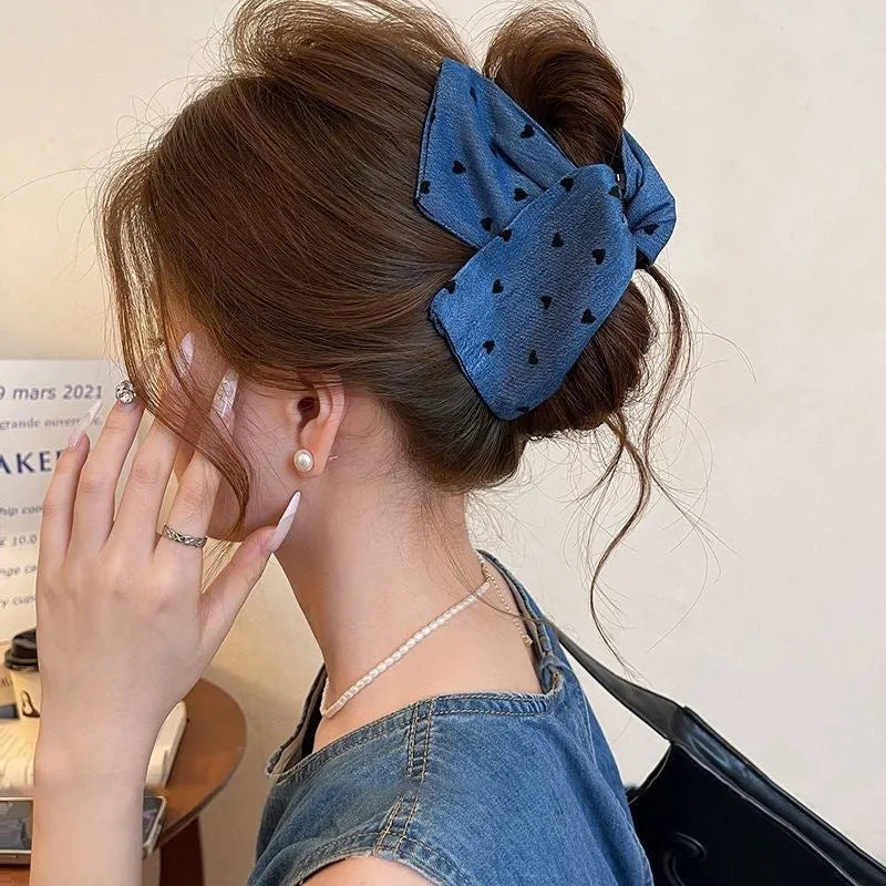 Handmade plastic hairpin with triangle grip shape and bow decoration