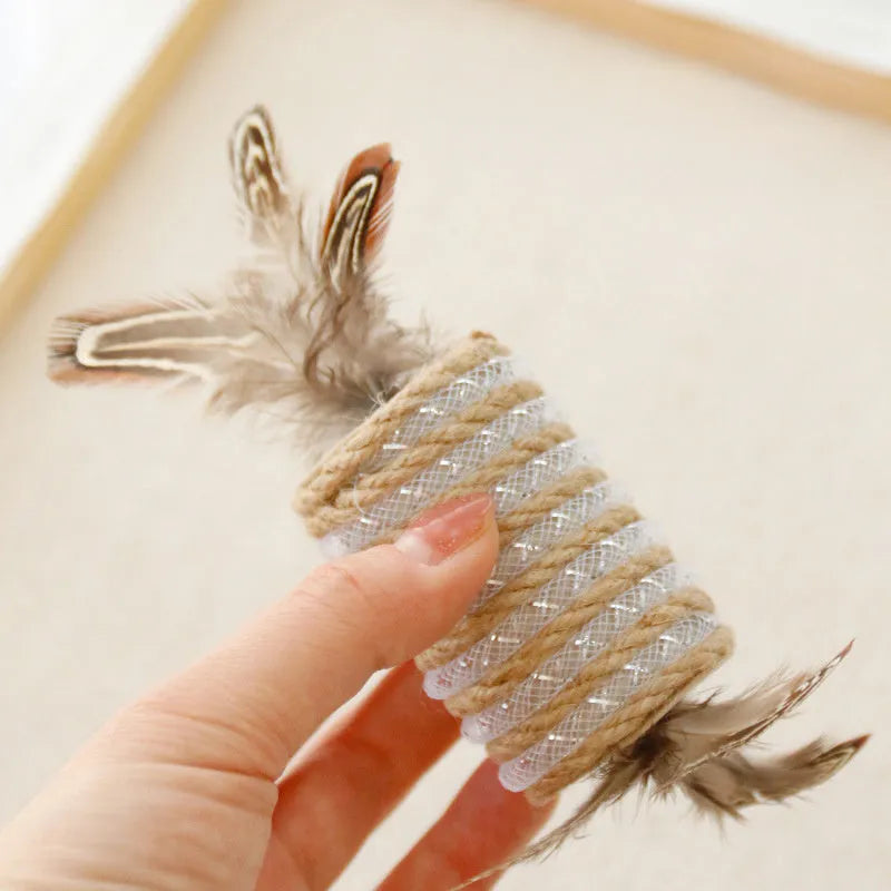 Beige cat toy with hemp rope, feathers, and a sound roller for scratching and interactive play.