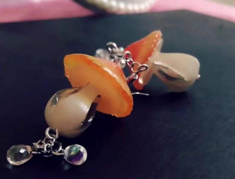 Resin heat shrinkable small mushroom earrings in yellow original style on plain background
