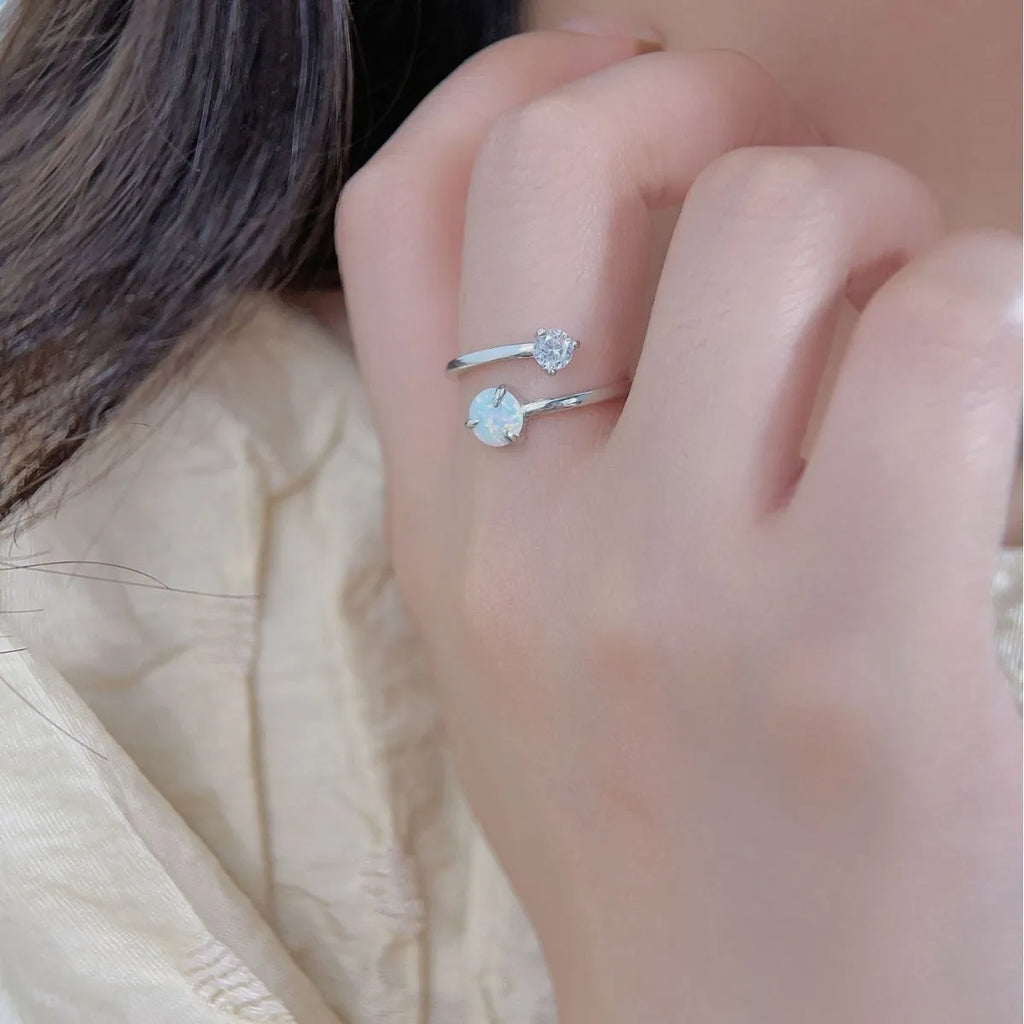 Open ring with adjustable opening, silver band, and inlaid zircon stones in gold colour