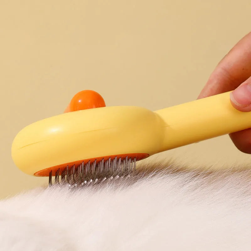 Small yellow duck-shaped pet comb for cat and dog grooming with open-section needle design