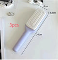 Roland purple self-cleaning hair brush with anti-static teeth and rotating telescopic handle on a white background.