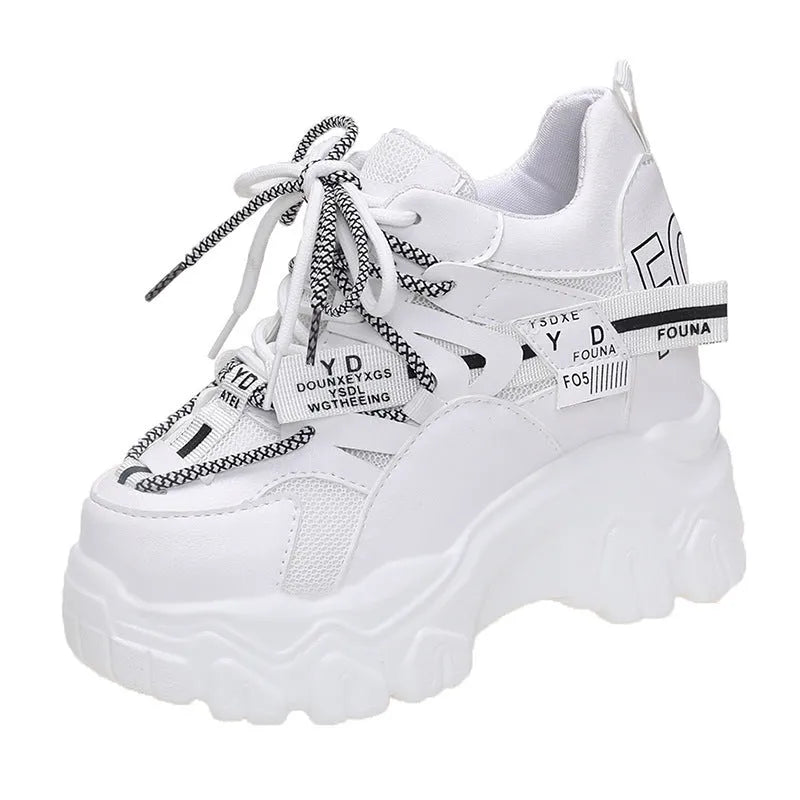 Women's white and black low-top mesh platform shoes with a cross strap and round toe on a rubber sole.