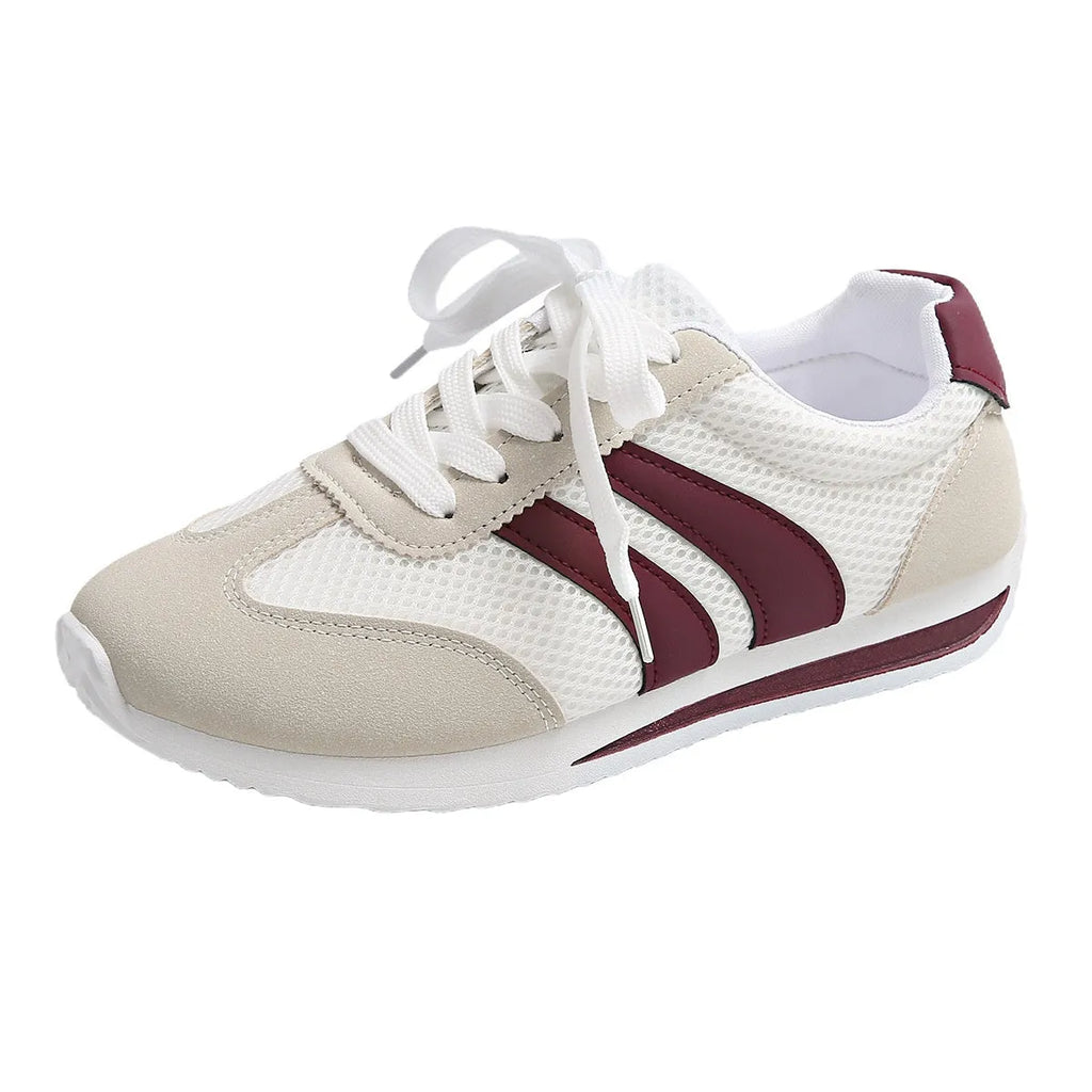 Wine red Cortez retro sneaker with cross straps, mesh lining, and flat rubber sole.
