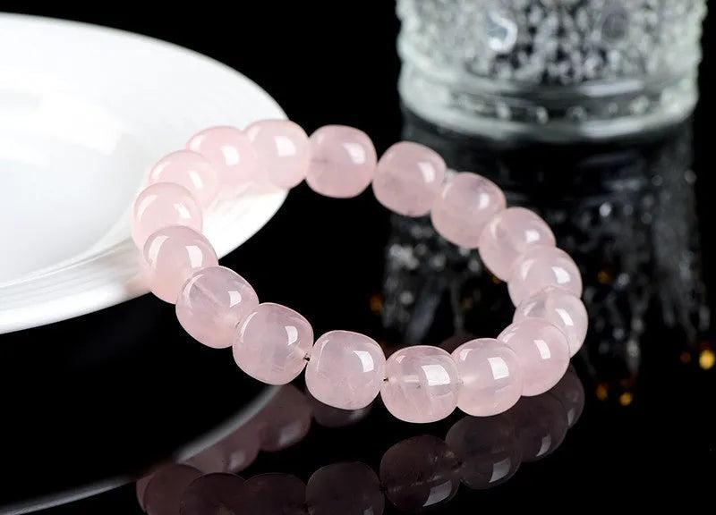 Pink unisex crystal bracelet with geometric barrel beads measuring 11-12 mm.