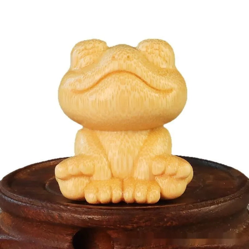Solid bamboo carving ornament of a smiling frog, 5cm high, cute cartoon style.