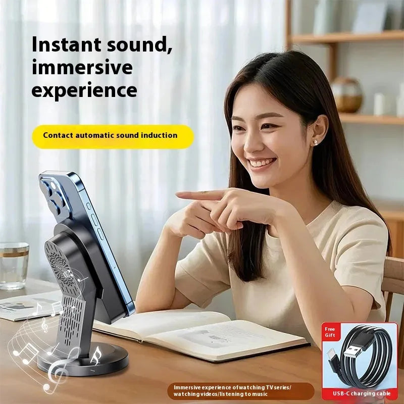Three-in-one wireless induction Bluetooth speaker bracket with phone holder, black colour, mirror finish, showing USB port and built-in battery