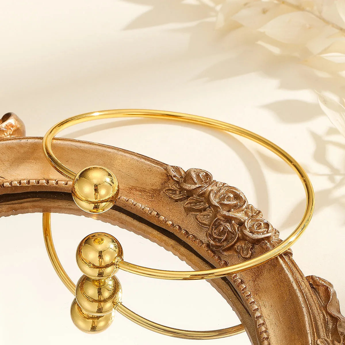 Golden copper plated 18k gold double bead opening bracelet on white background