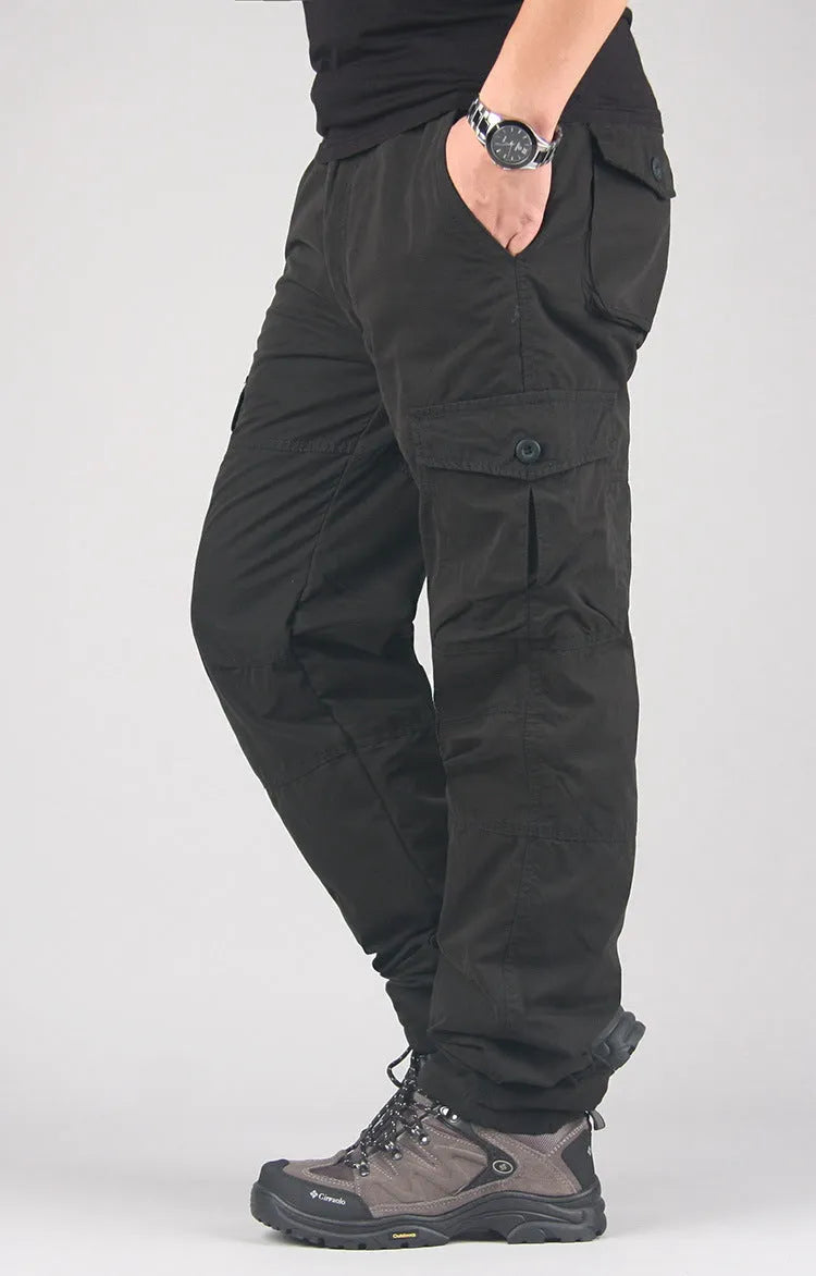 Men's thick khaki wool-lined cotton overalls with loose straight legs on a hanger