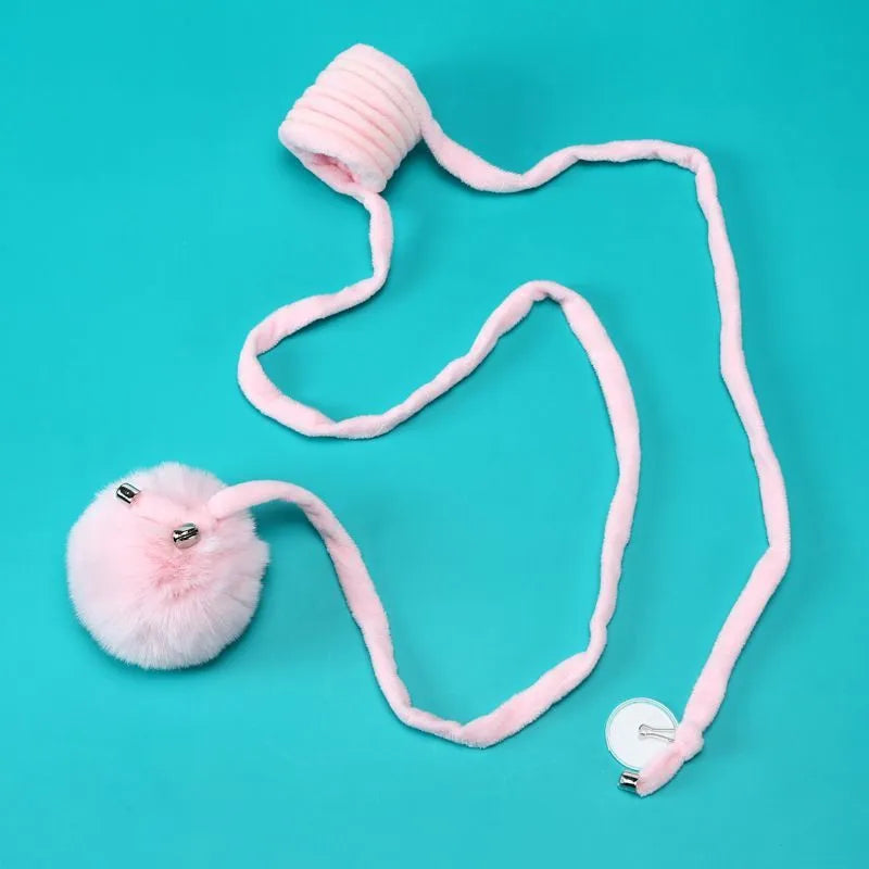 Cat toy with suction cup, spring, rabbit fur ball, and retractable elastic rope on a door