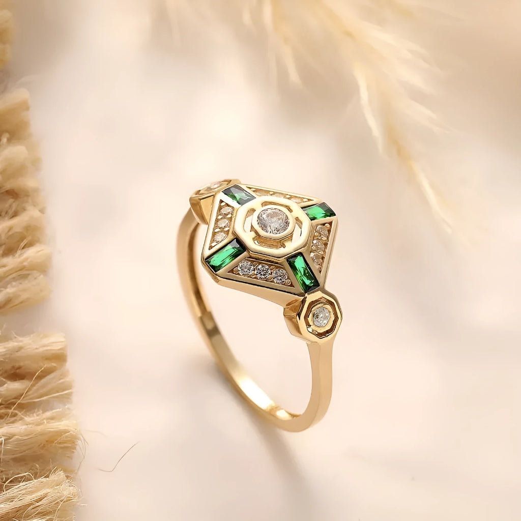 Square emerald-coloured gemstone ring for women on a plain background.