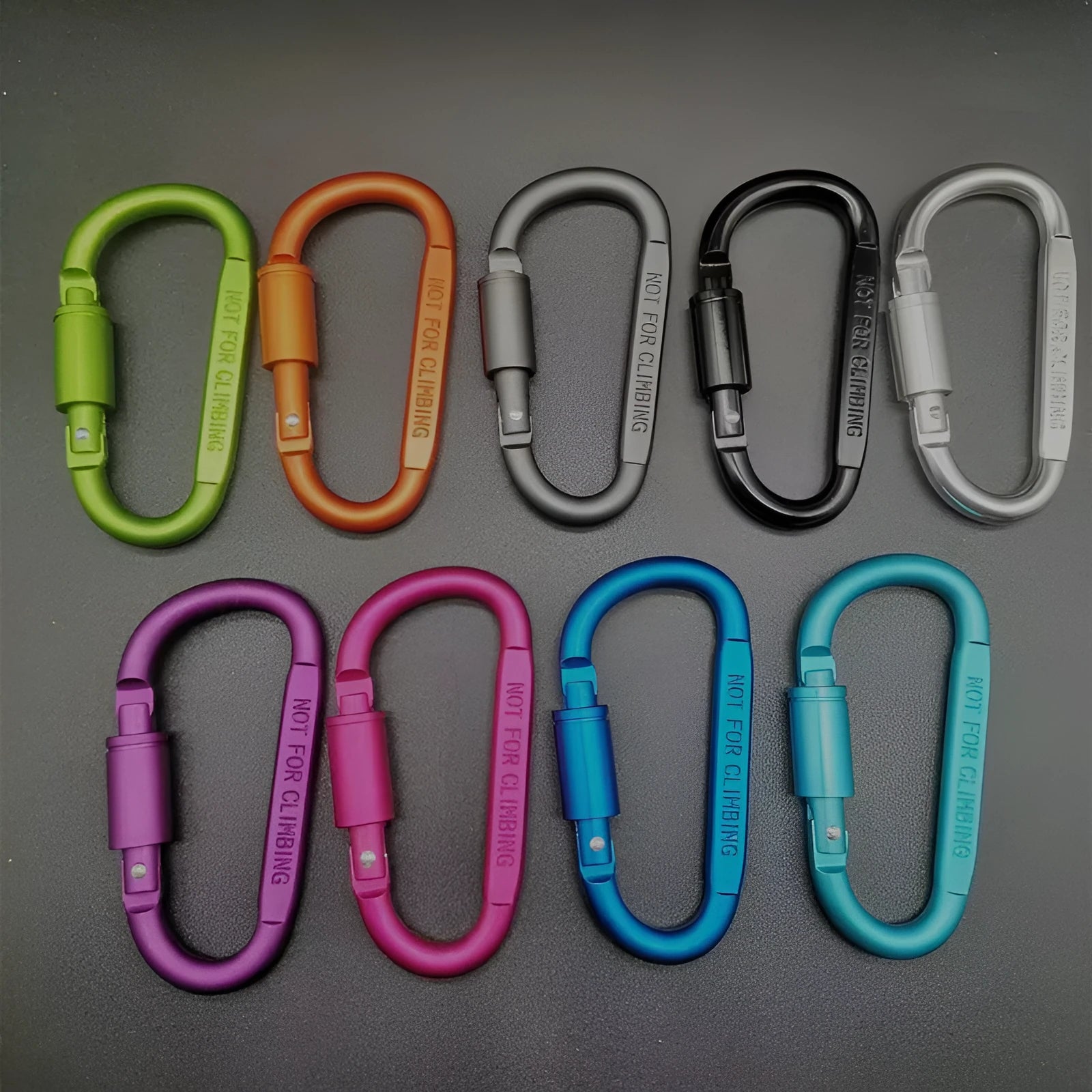 D-type aluminium locking carabiner in a selection of ten colours on a grey background.