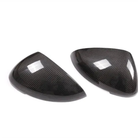 Pair of real carbon fibre rearview mirror covers for Porsche Macan, showing black woven texture.