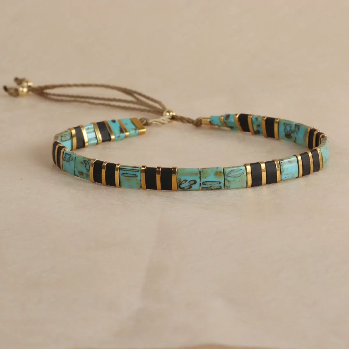 Geometric beaded bracelet with round glass and coloured glaze beads in five colour options.