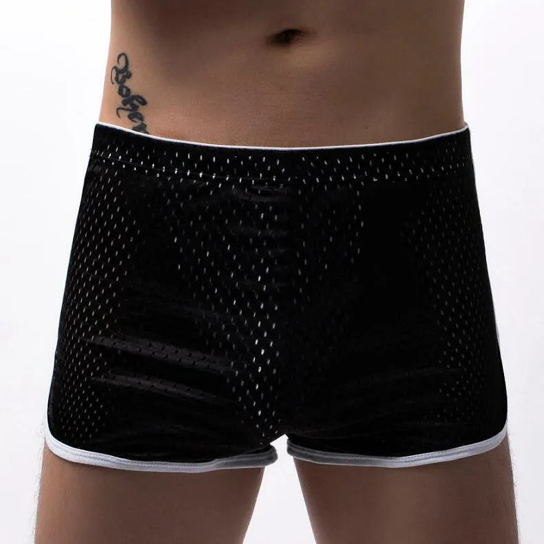 Men's cotton three-point boxer shorts in light blue, laid flat to show mid-waist design and trunk style.