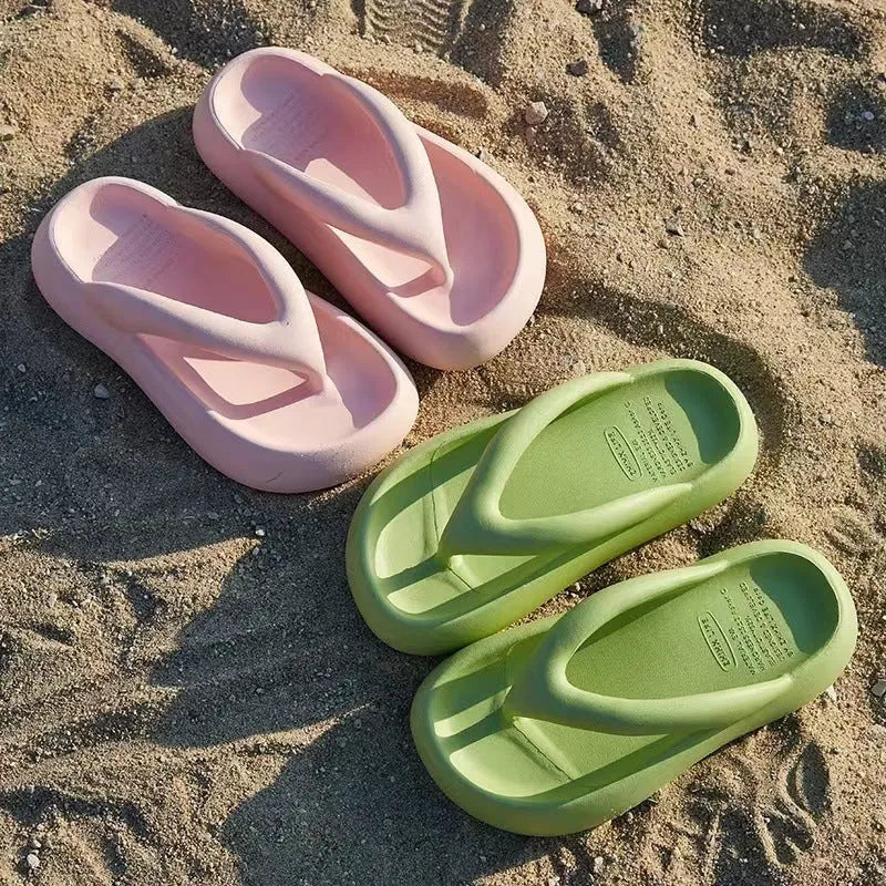 A pair of solid-colour thick-soled EVA flip-flops with a decorative bow on the thong strap.