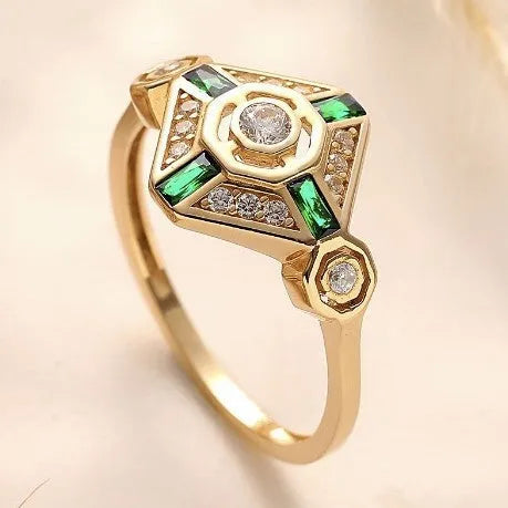 Square emerald-coloured gemstone ring for women on a plain background.