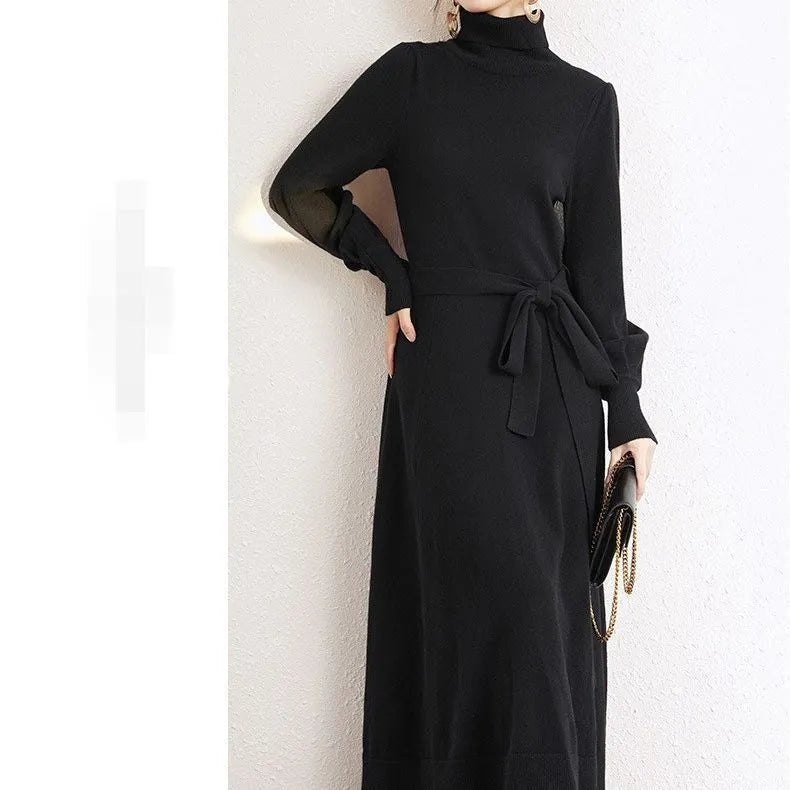 A rose red turtleneck knit dress with long sleeves, a loose hem, and an elastic waist on a hanger.