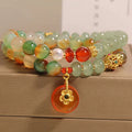 Women's peacock green agate double ring bracelet with alloy construction and safety buckle clasp.