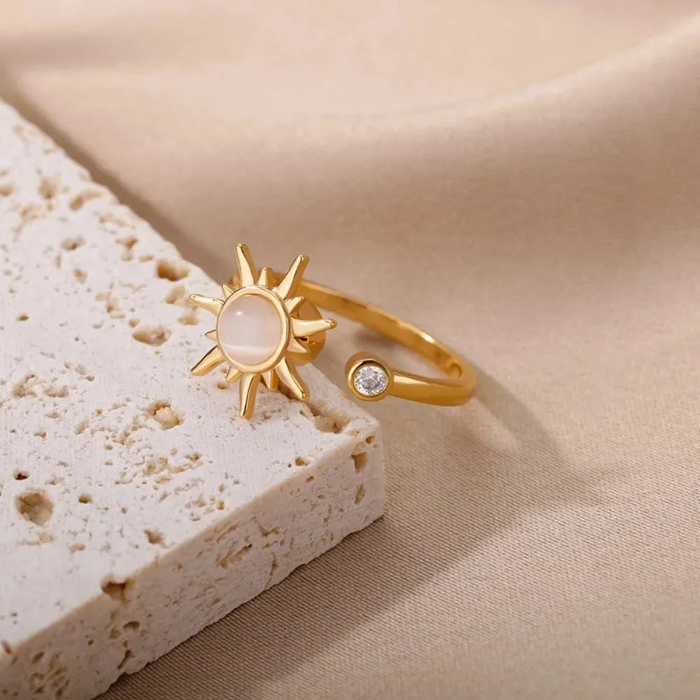 Adjustable rotating decompression ring in gold electroplated copper with geometric design