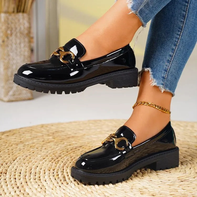Women's black chunky heel round toe pumps with thick rubber sole and metal decoration