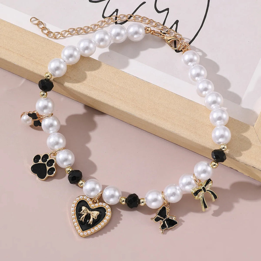 Cartoon pattern monochrome pet pendant necklace on a white background – pearl-like material, black colour option