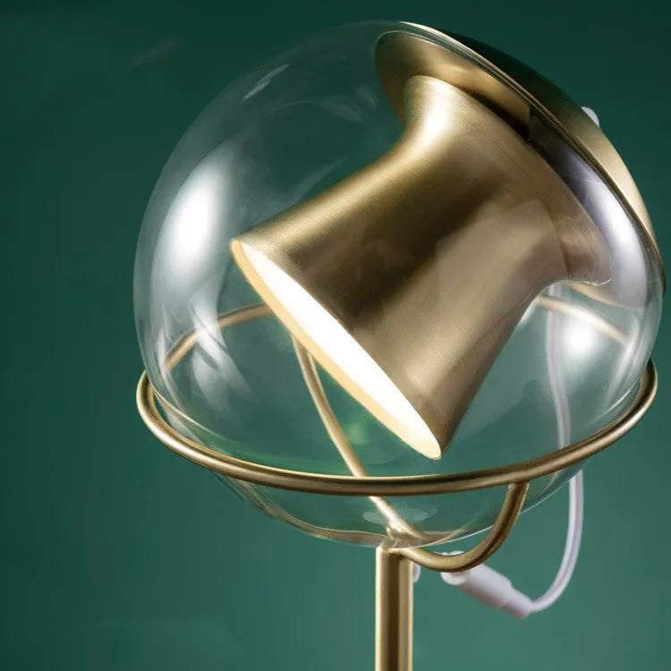 Dimmable touch-controlled desk lamp with glass shade on wooden desk
