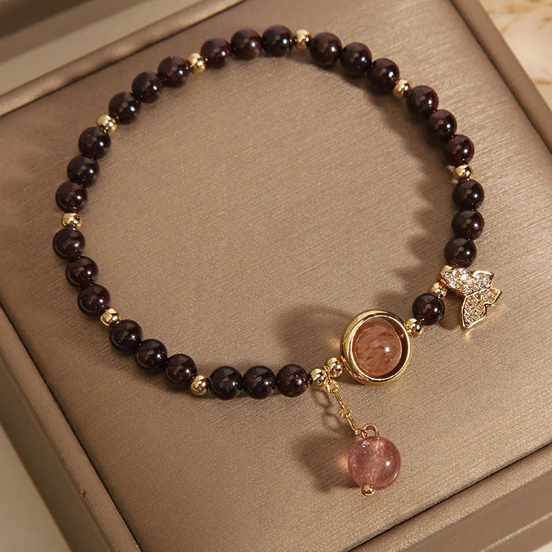 Black butterfly pendant bracelet with stone construction and red rock elements