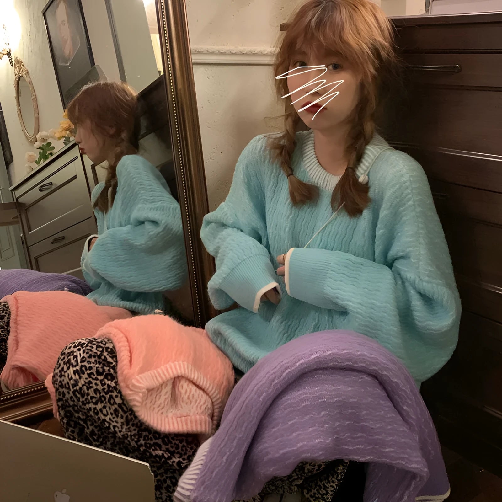 A woman's loose-fit solid colour pullover sweater in lake blue, made from polyester fibre.
