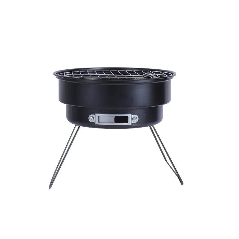 Small folding round metal ice stove with grill mesh and legs set up for outdoor barbecuing.
