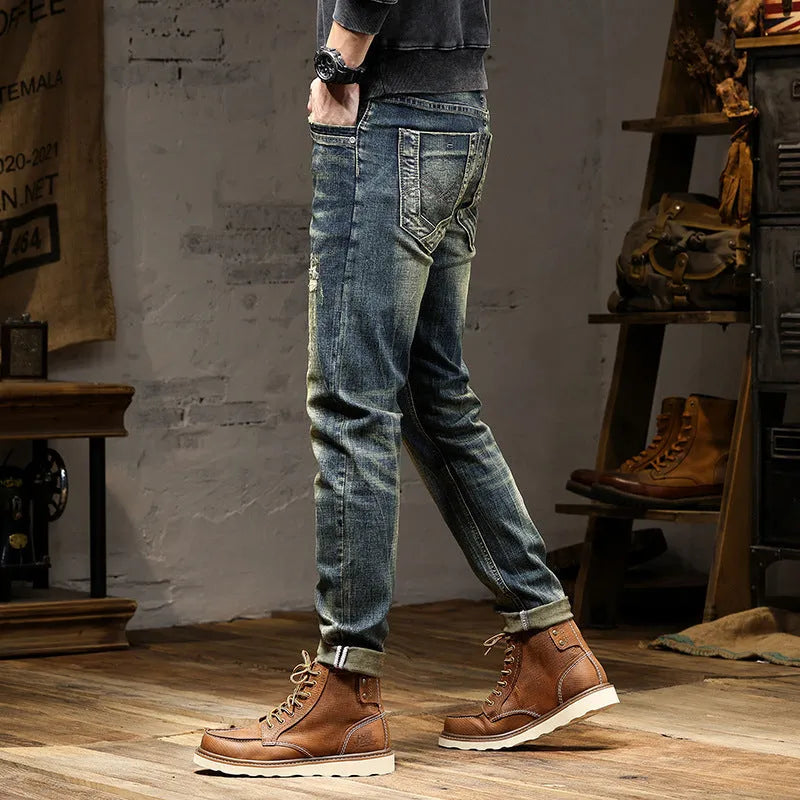 Men's skinny fit jeans in a retro blue wash with a zip fly, shown laid flat.