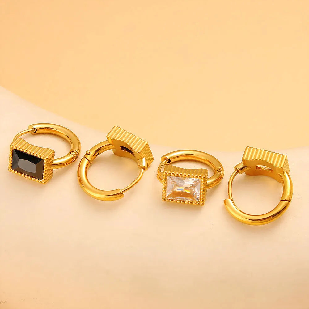 A pair of square-shaped stainless steel earrings with round zircon accents in a choice of black, green, or white.