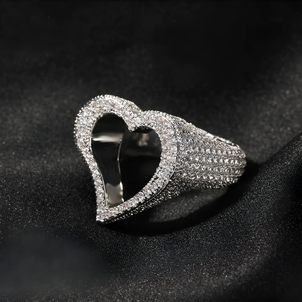 Gold copper ring with hollow heart cut-out and zircon stone on finger