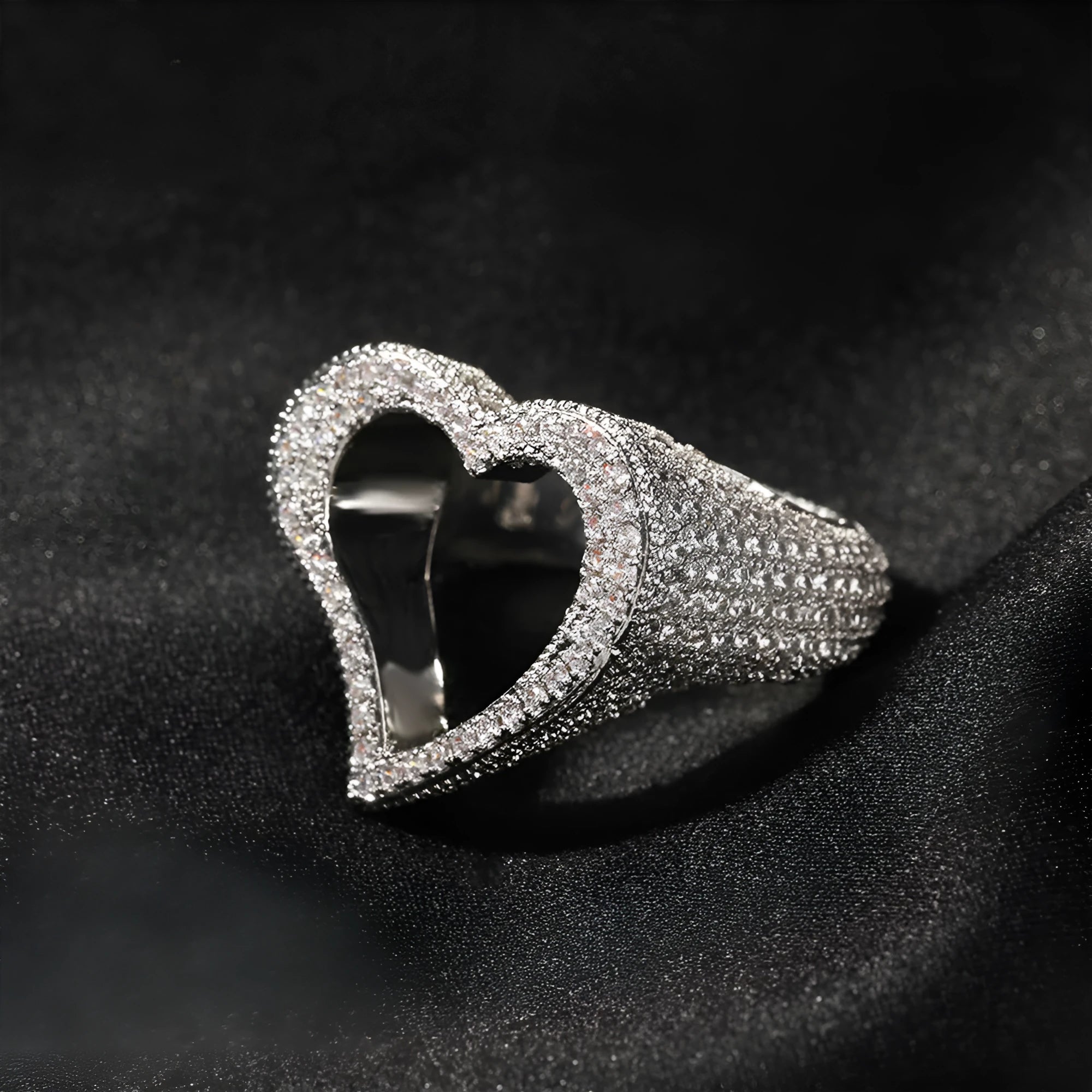Gold copper ring with hollow heart cut-out and zircon stone on finger