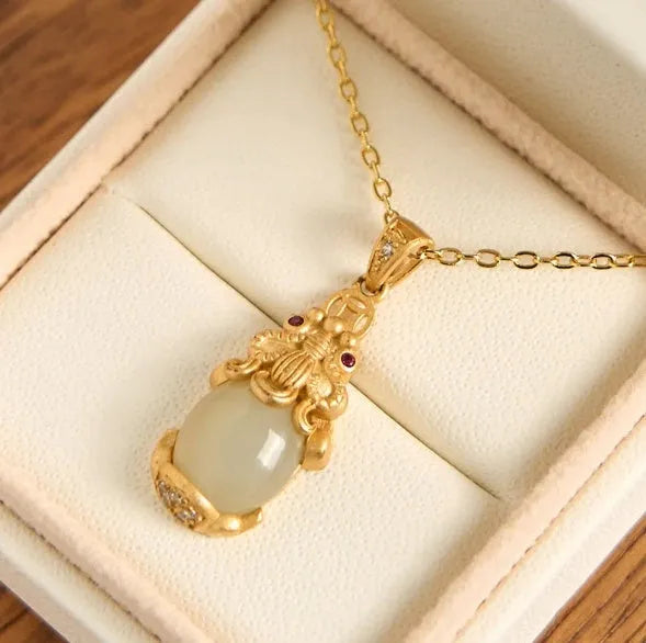 Hetian jade antique gold pendant necklace with cartoon pi xiu design and cross chain.