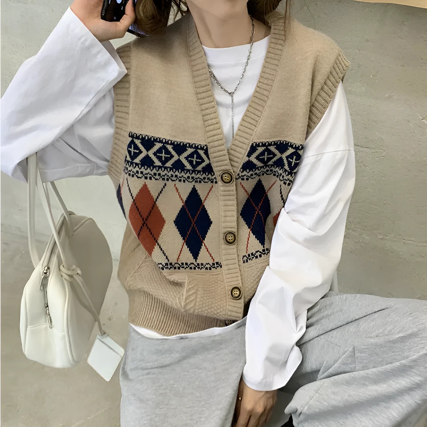 Sleeveless loose cardigan top in diamond plaid pattern, shown in khaki colour.