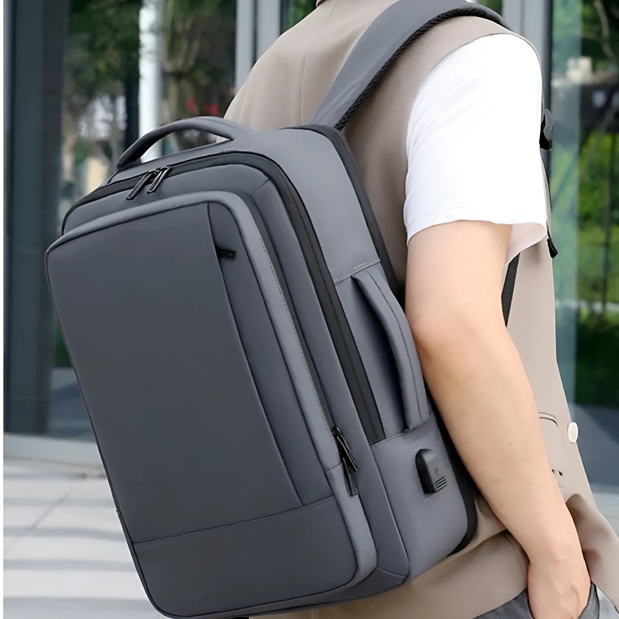 Large black waterproof backpack with curved shoulder straps for business travel and commuting