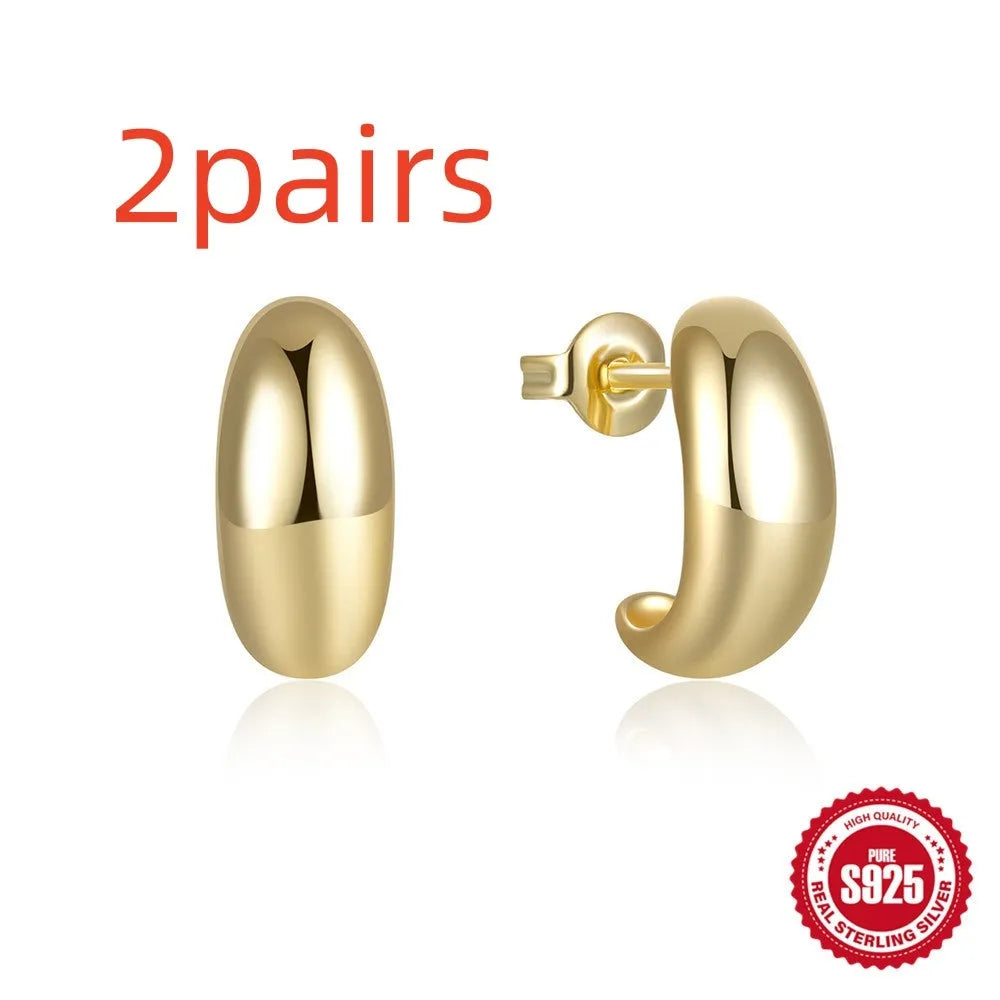 Sterling silver C-shaped stud earrings with glossy electroplated finish