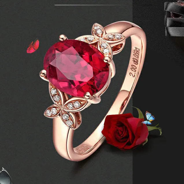 Close-up of a women's rose gold plated butterfly ring shaped like a heart with coloured enamel details.