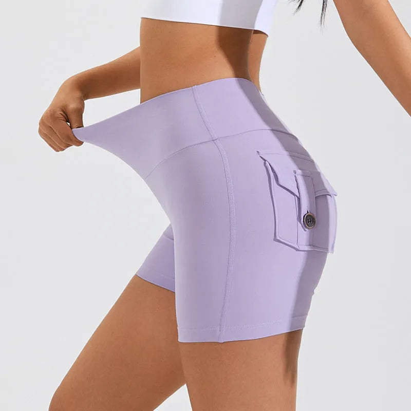 Women's high waist hip lifting fitness shorts in a solid colour with side pockets, on a mannequin.